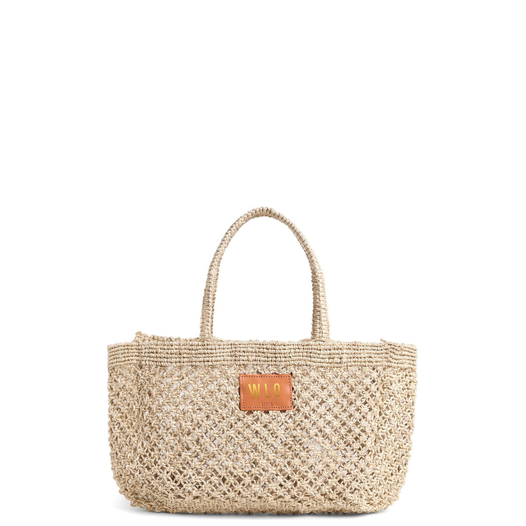 Petite Mercado Tote in Natural — handwoven open-weave jute tote, front view with gold foil monogram on the leather patch
