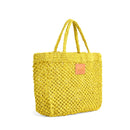 Petite Mercado Tote in Ocre — three-quarter view showing the open weave and crocheted handles, gold foil monogram on the leather patch