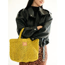 Petite Mercado Tote in Ocre — held in front of the body, styled with a black leather jacket over a leopard-print skirt
