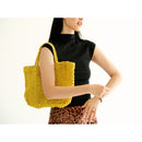 Petite Mercado Tote in Ocre — carried over the shoulder, shown in profile against a plain studio background